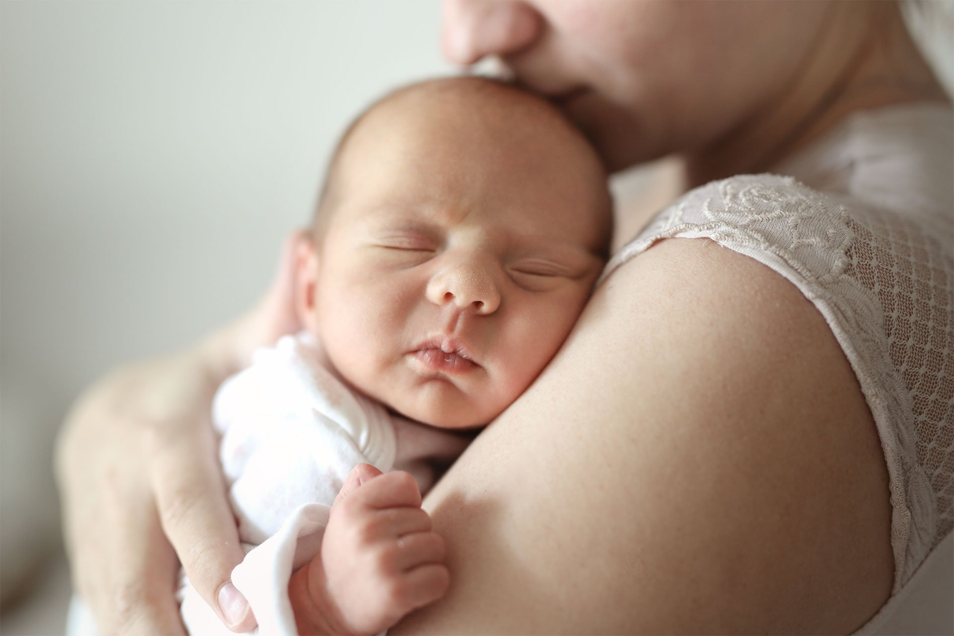 Mamá cargando a su bebé dormido